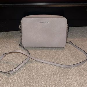Gently used Michael Kors Jet Set Large East West Leather Crossbody in Aluminum.